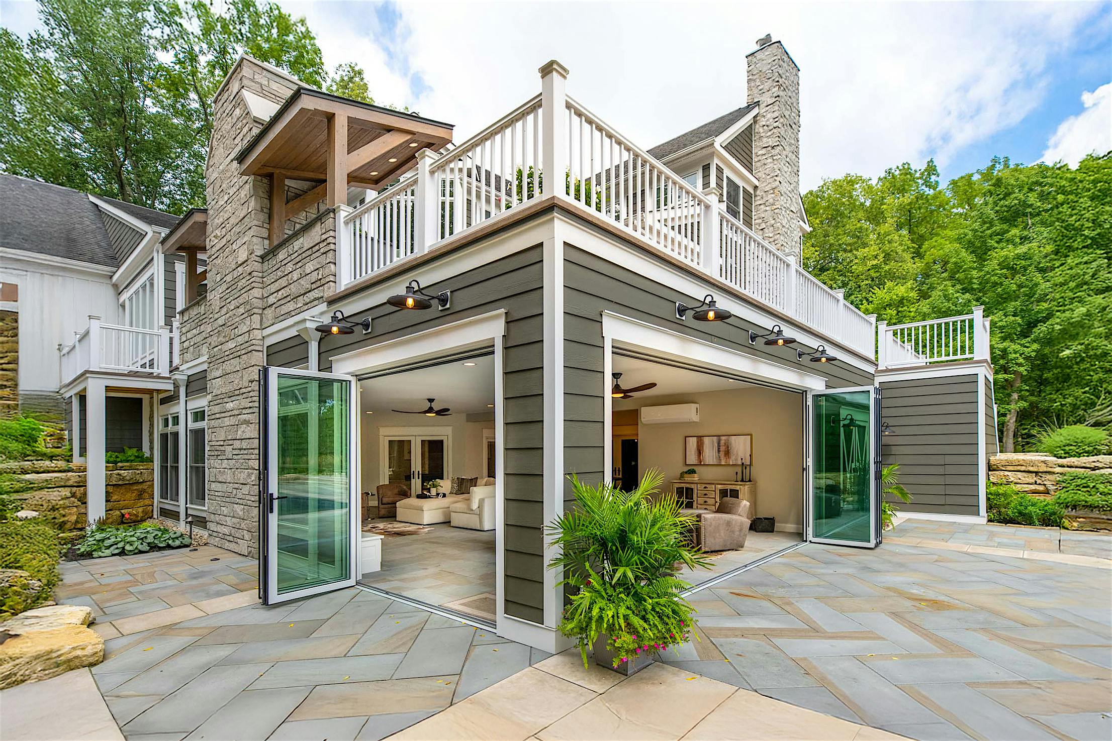 Accordion glass doors at Columbus, OH River House, creating a seamless four-season sunroom with modern indoor-outdoor flow