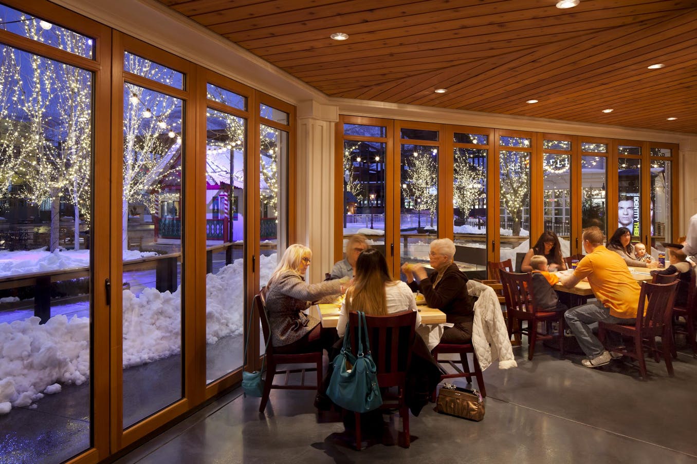 Restaurant sitting area with large wood framed folding glass wall