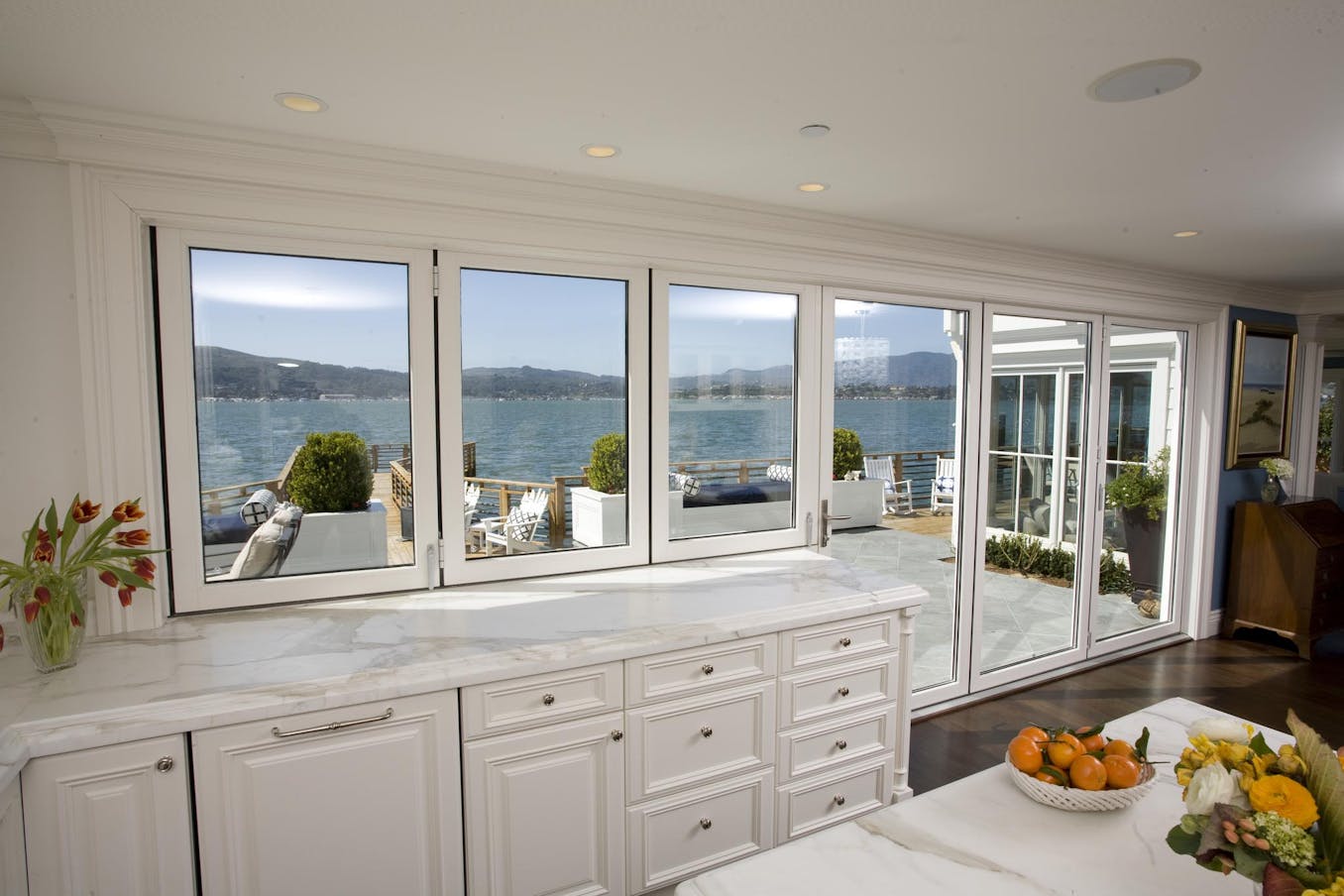 A kitchen with folding triple glazing doors and a view of the ocean