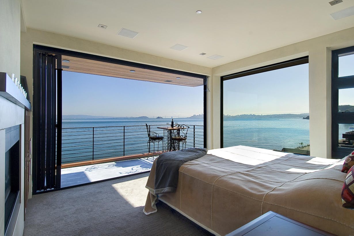 Oceanview master bedroom with folding glass walls