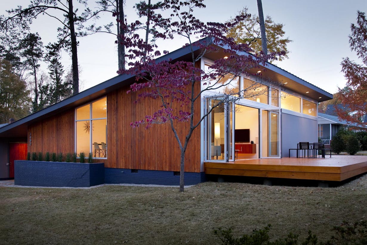 A modern house in the woods at dusk