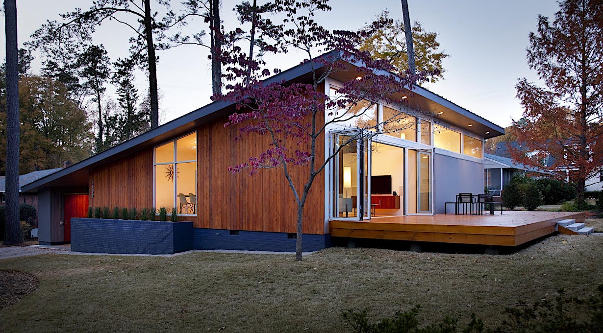 A modern house in the woods at dusk