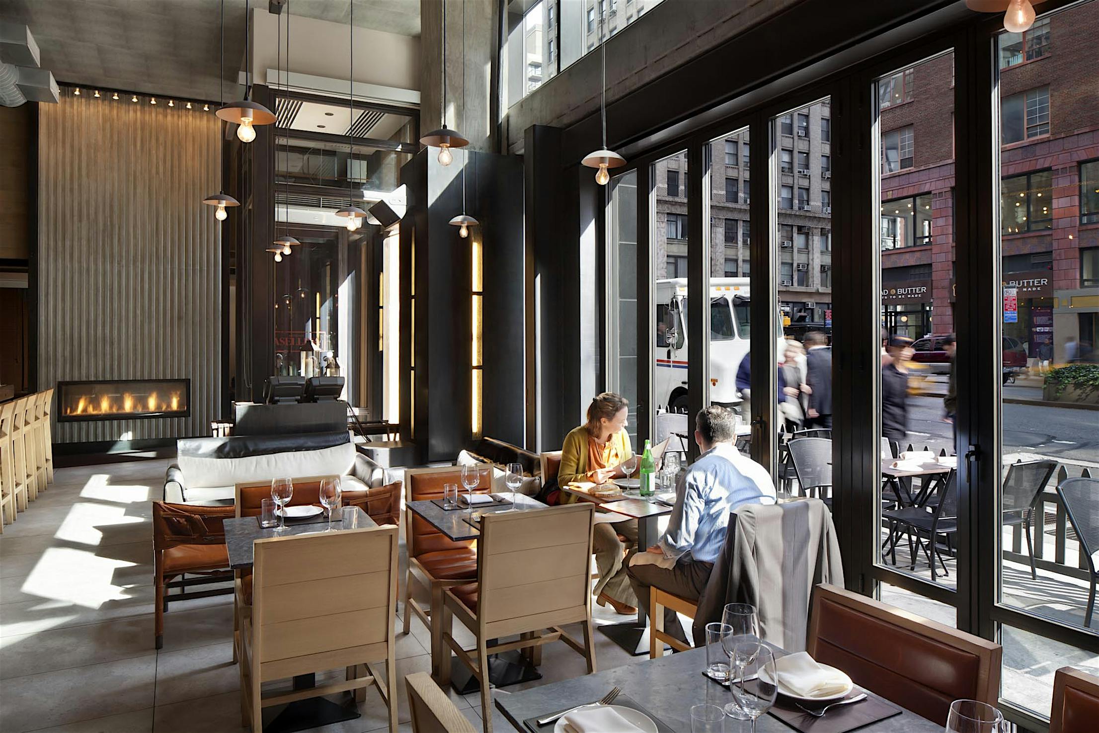 A restaurant with large glass wall and a view of the city