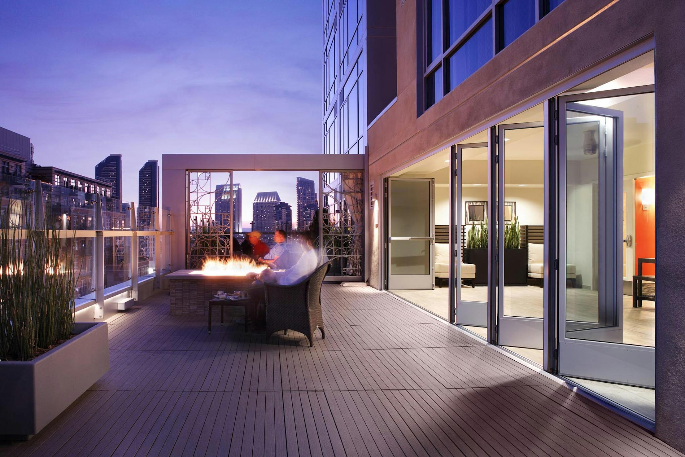 Hotel rooftop deck with folding glass walls 