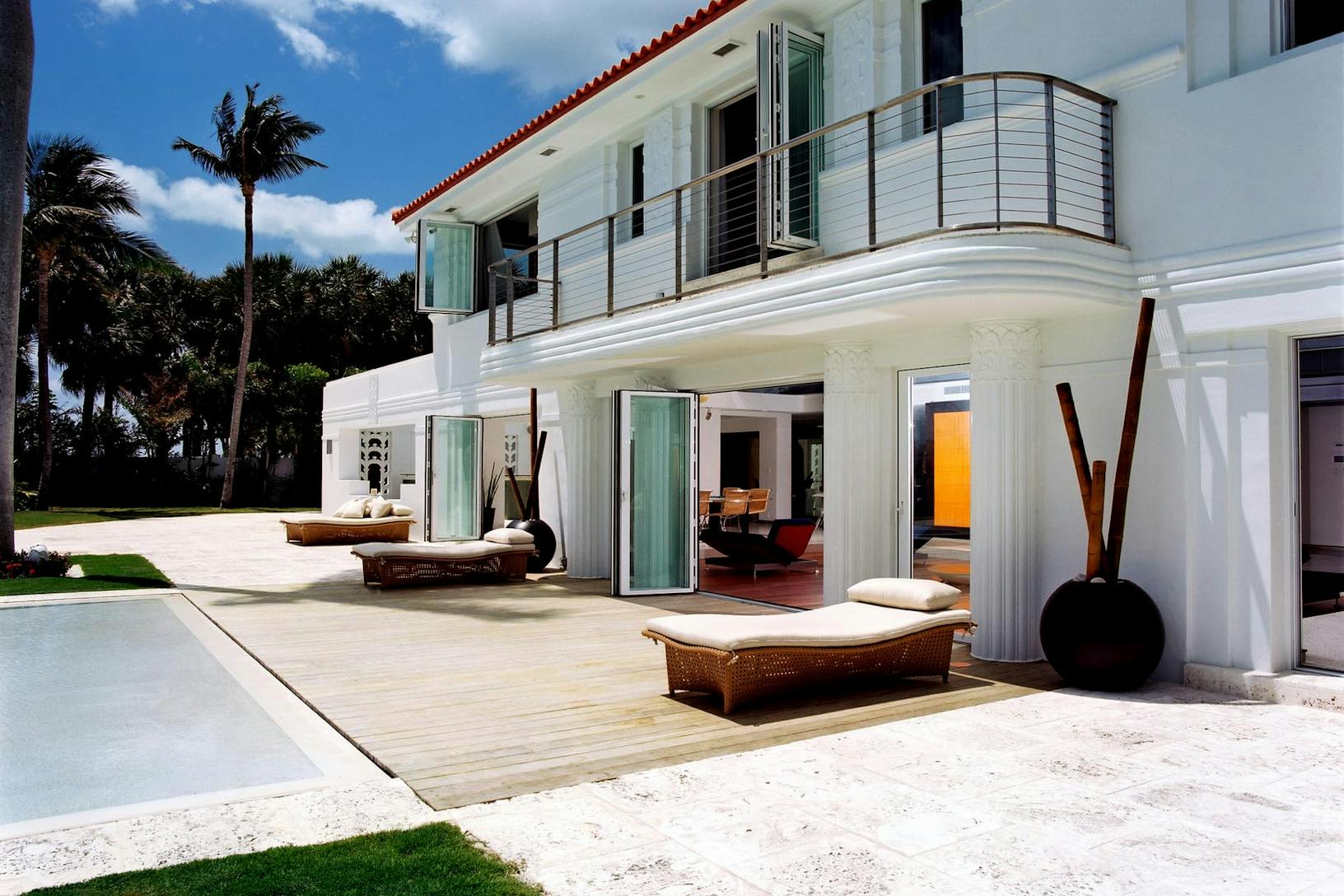 Sl73 white beach house exterior with extreme weather performance glass walls