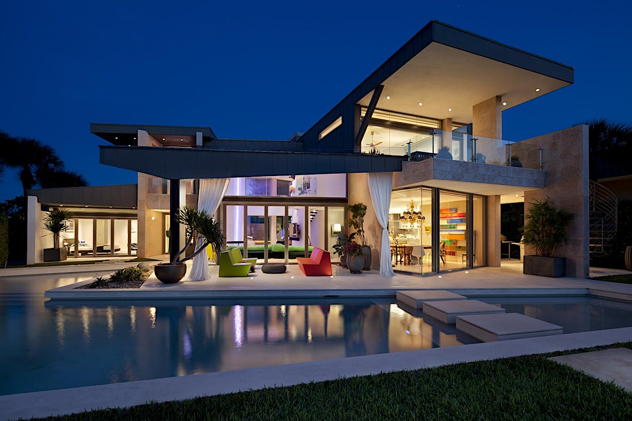 A modern house with a swimming pool at nigh