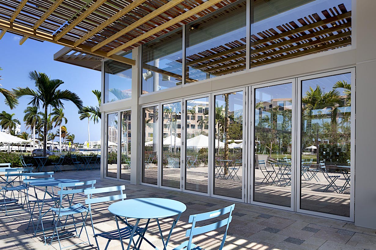 Weather resistant folding glass walls 