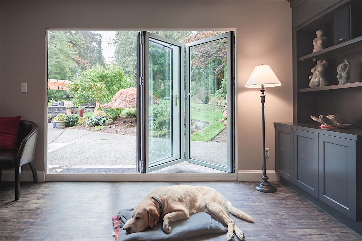 Retractable patio doors in South Surrey, BC integrate indoor and outdoor space via sleek small‑opening glass design