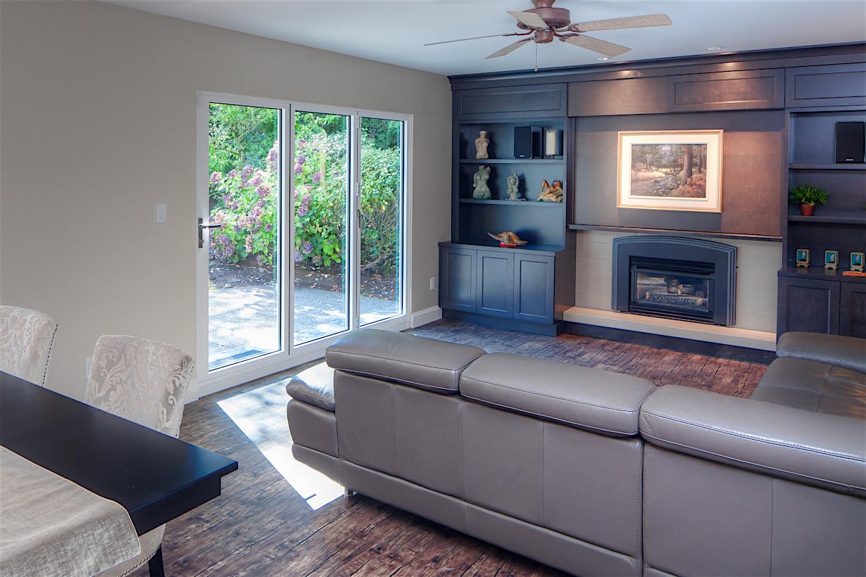 Accordion patio doors with small opening maximize space and indoor-outdoor flow in South Surrey, BC residence