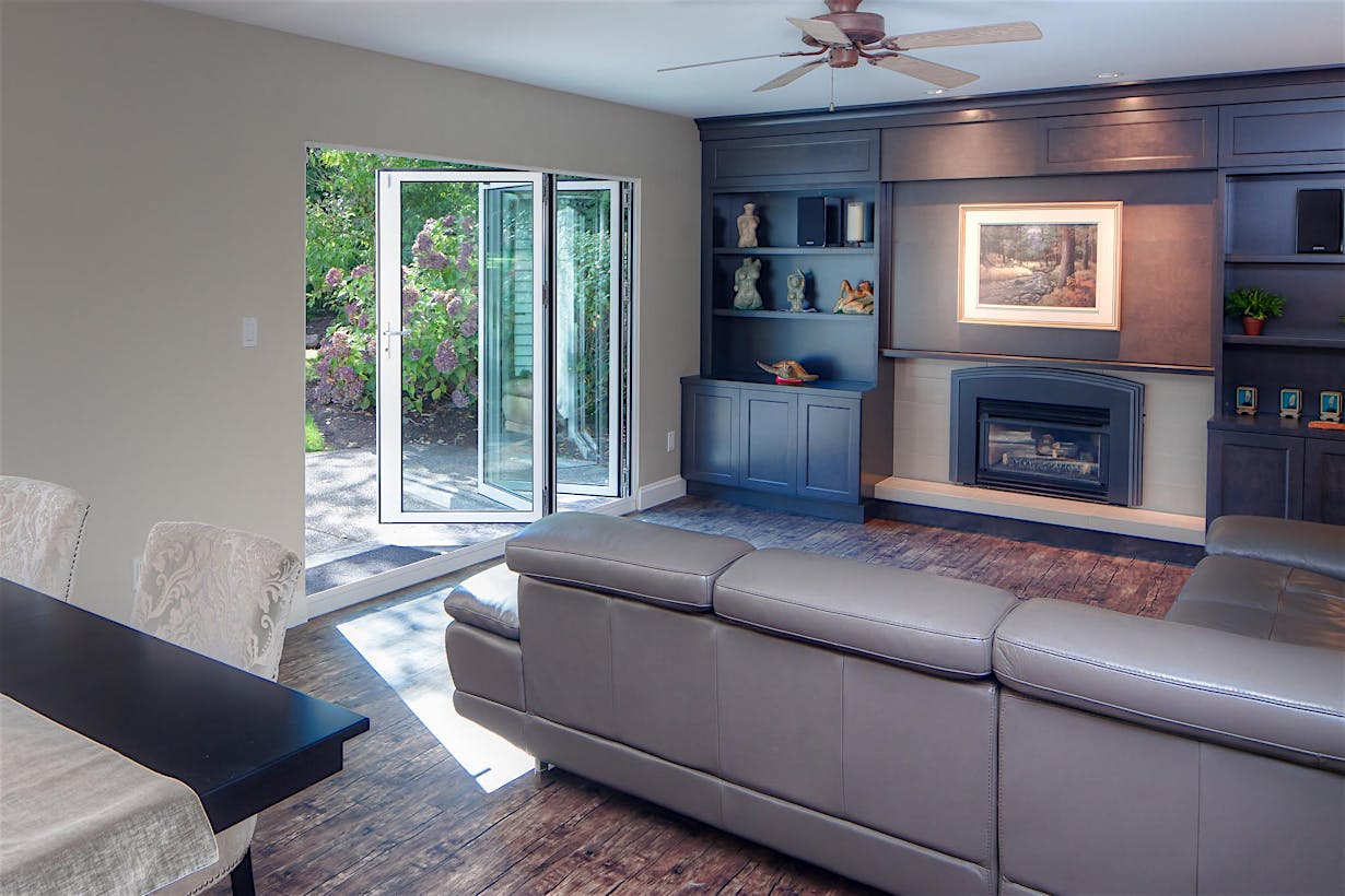 Partially open accordion patio doors with small opening enhance indoor-outdoor living in South Surrey, BC residence