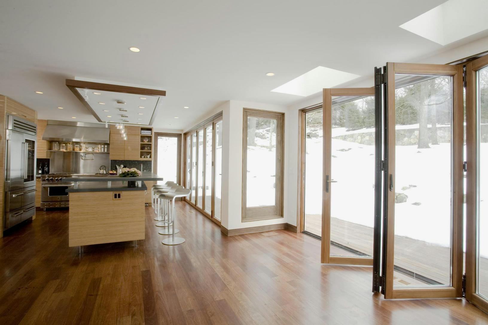 Modern open kitchen layout with island and folding patio doors