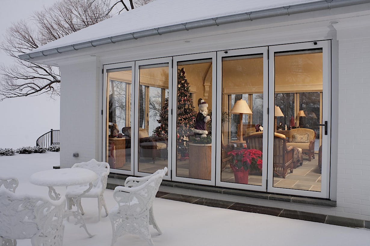 NW Clad 740 Four season porch with sealed operable glass walls on a lakeside house