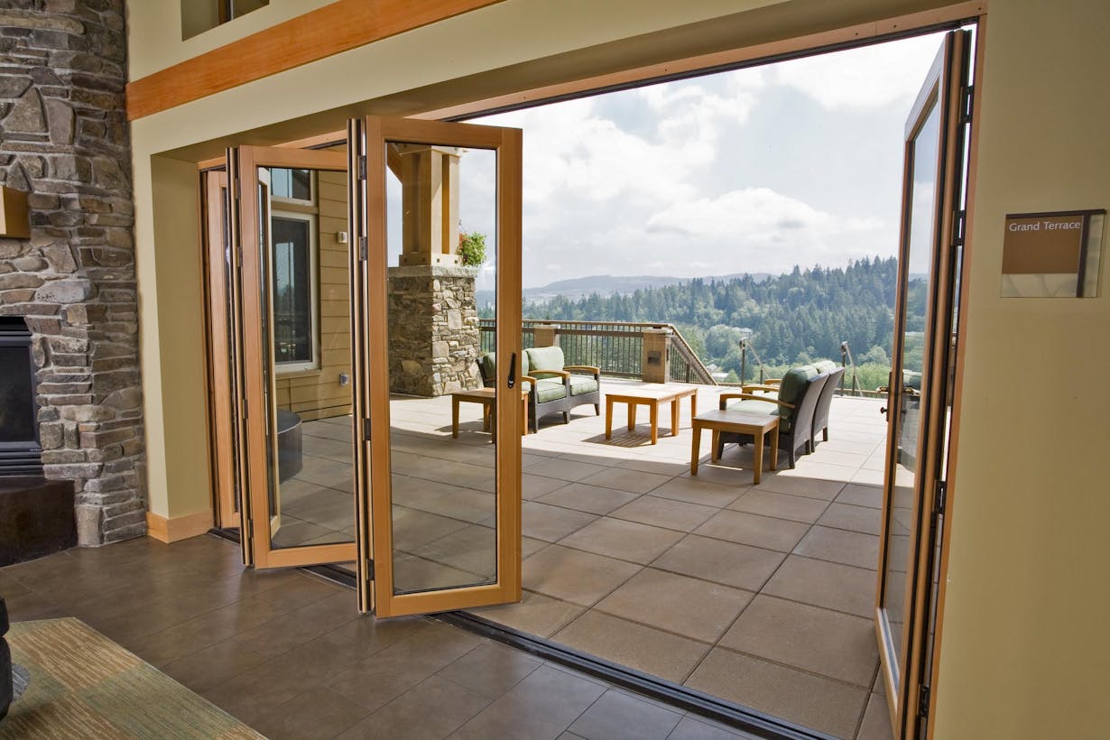 Wood framed folding patio doors with mountain view