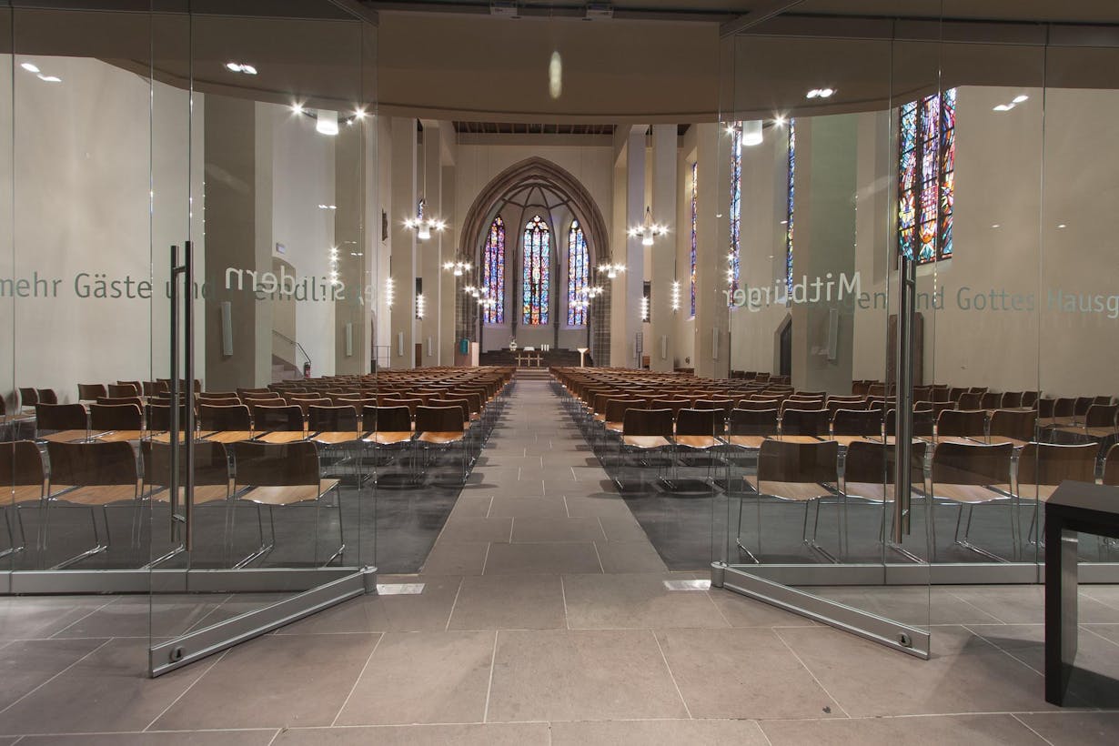 a large empty religious building with all glass folding walls