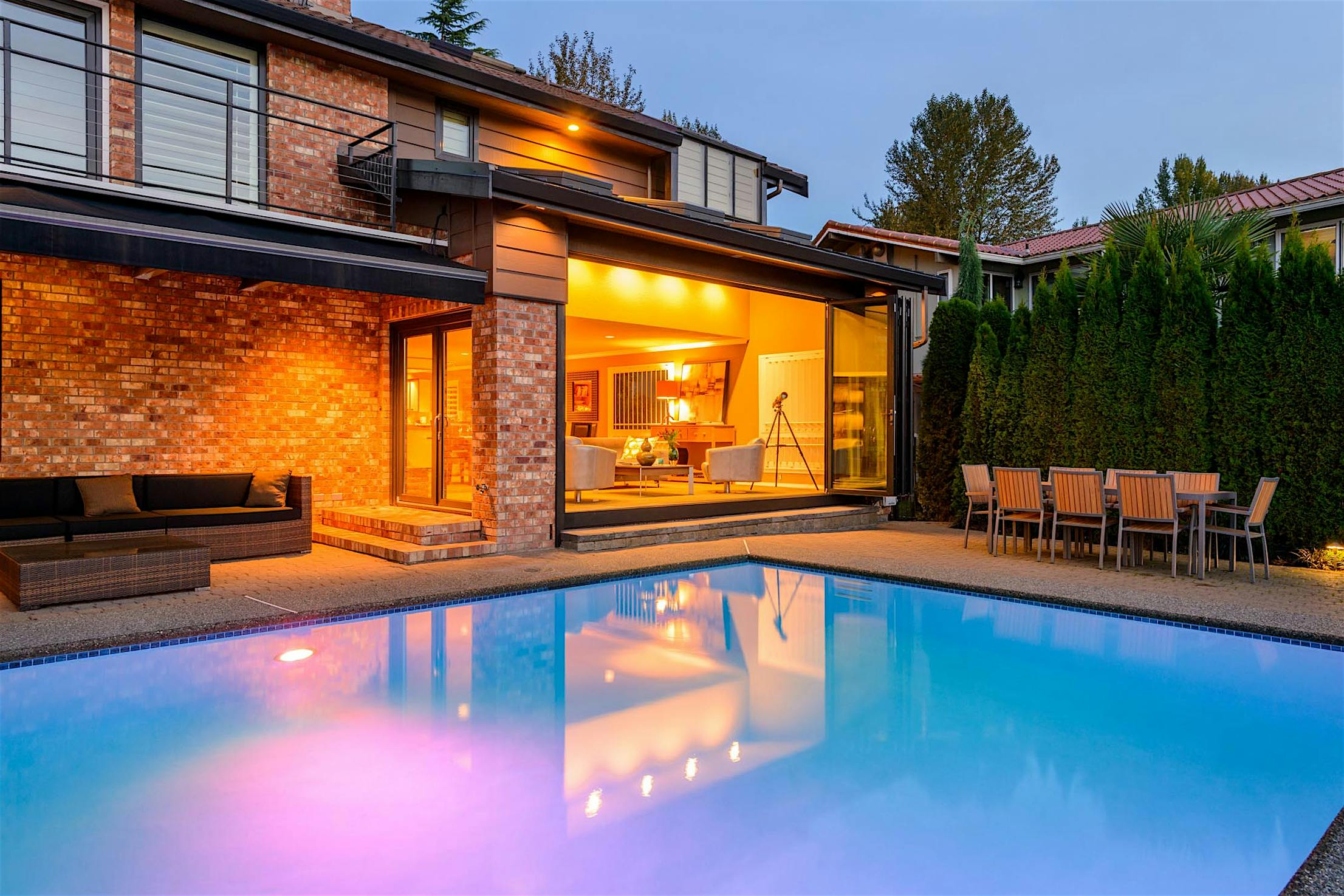 SL70 Brick house exterior design with a swimming pool - Opened folding glass walls night view