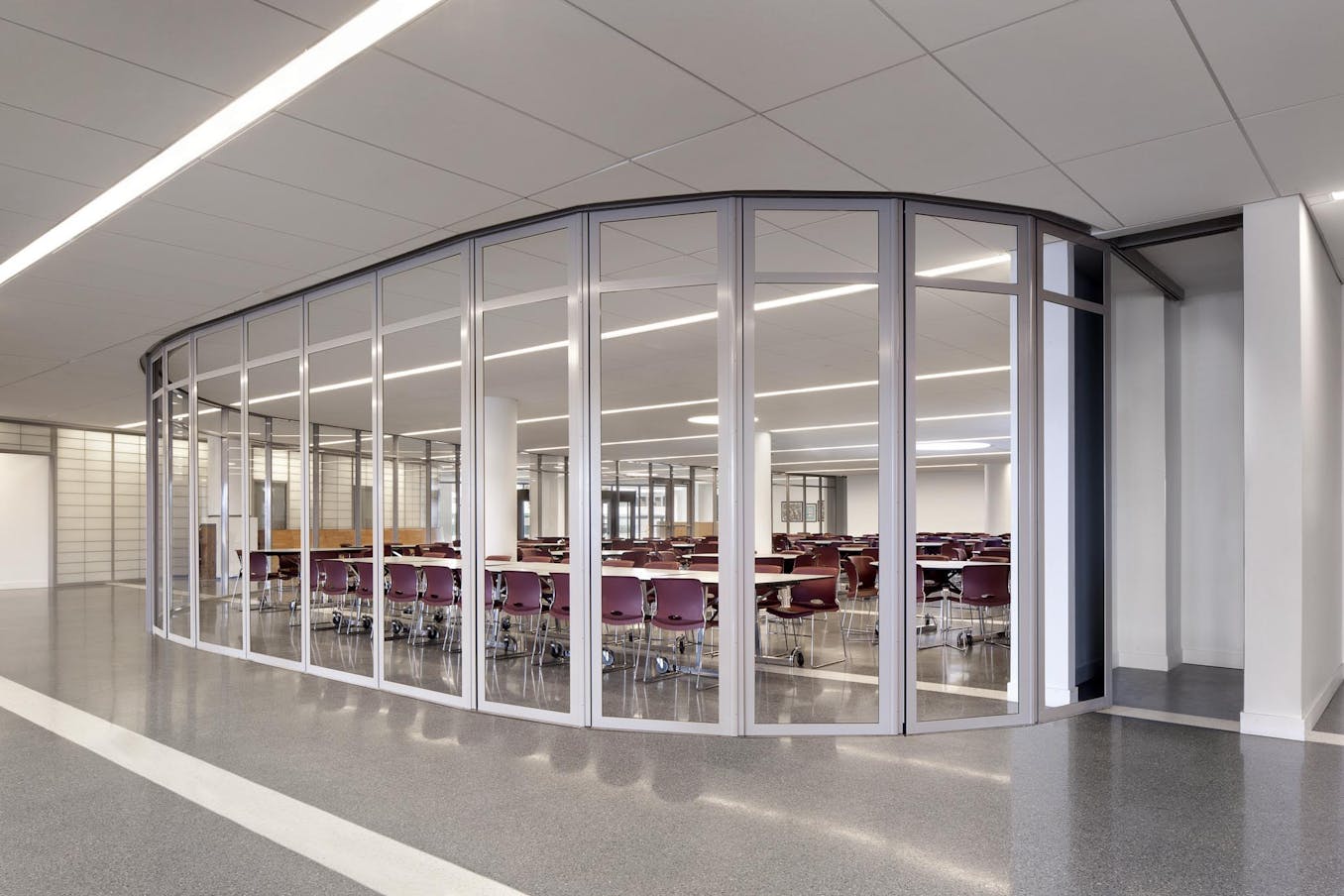 commercial collaborative learning space in school design - segmented curved sliding walls closed exterior