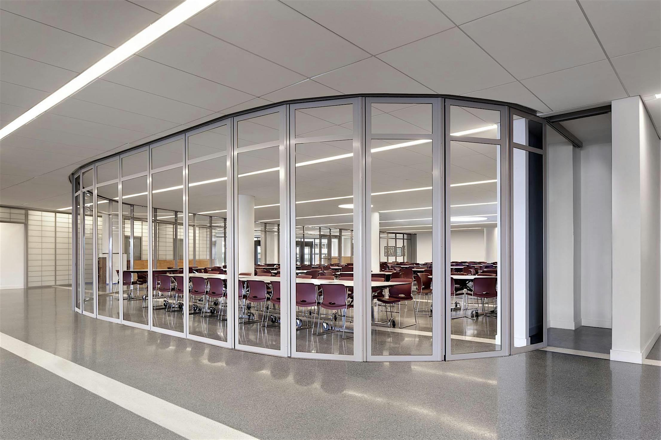 Commercial segmented curved sliding glass walls at The Union Nations International School in NY