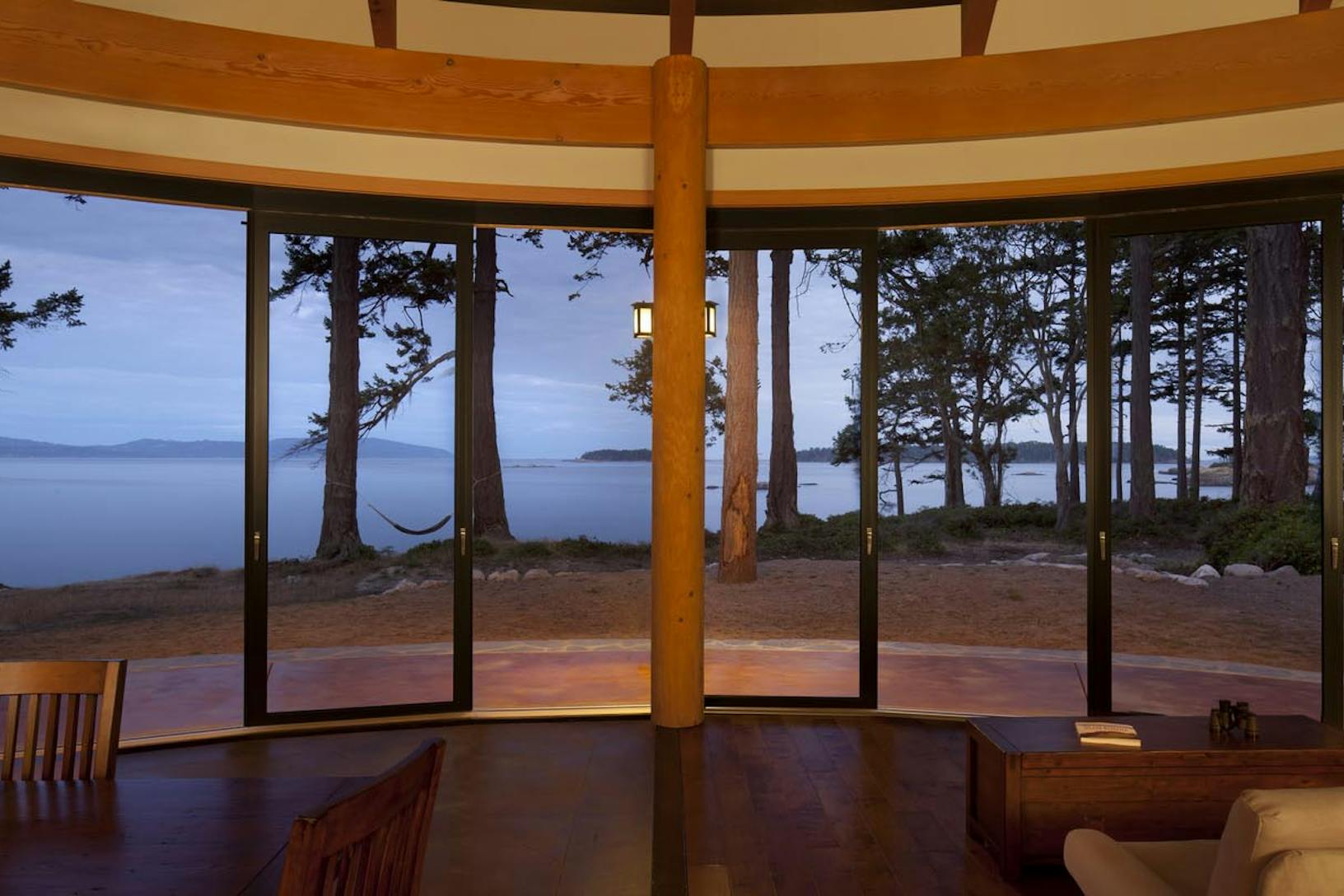 HSW60 cabin in the woods with segmented curved glass walls design