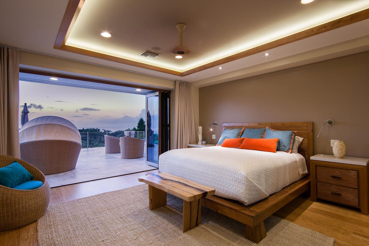 Open-air bedroom with folding deck doors