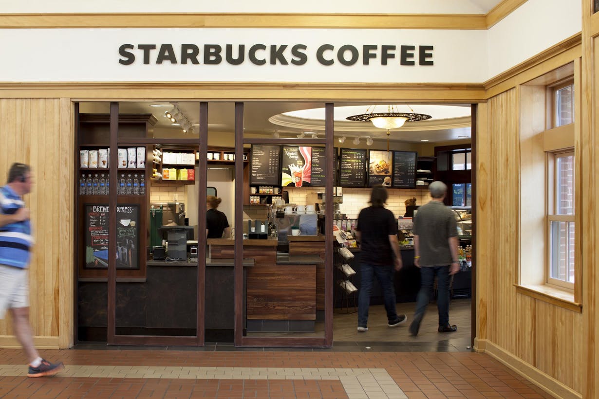 Retail Starbucks coffee storefront - wood framed sliding glass doors