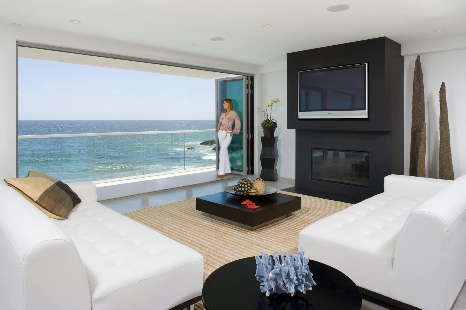 Oceanfront living room with a large folding balcony doors