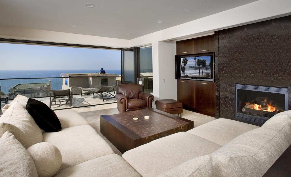 Beach Home Living Room Lit up with Floor to Ceiling Glass Walls  - Folding