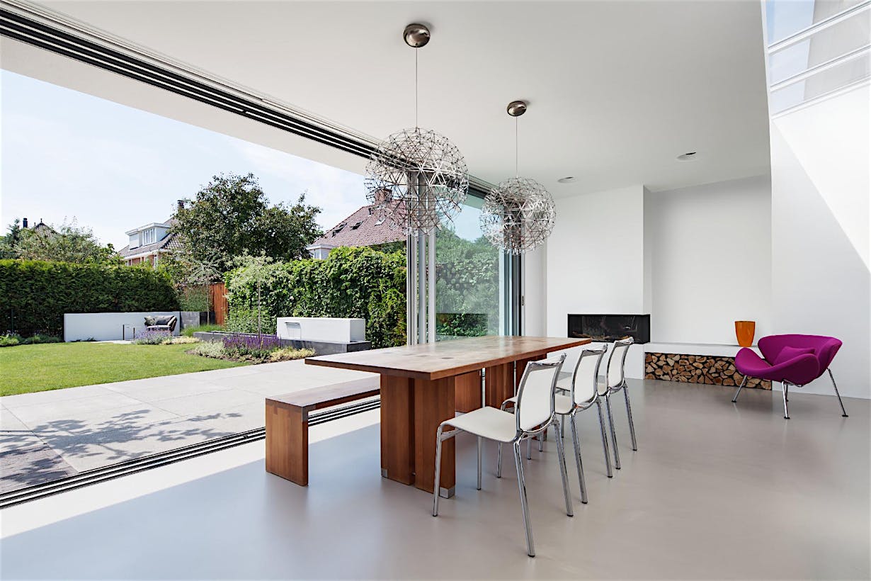 Sliding glass doors integrate indoor and outdoor space, creating a seamless connection for modern open living