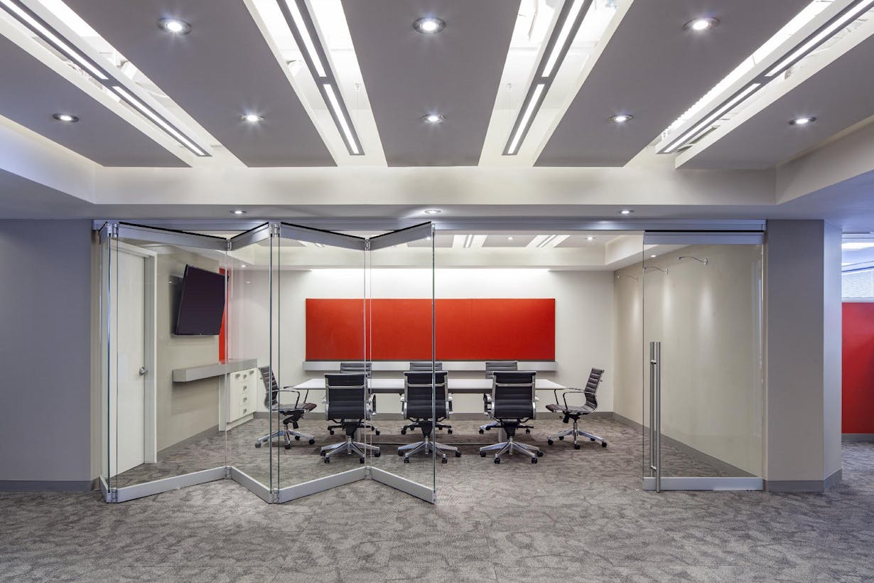 A conference room with folding glass partitions