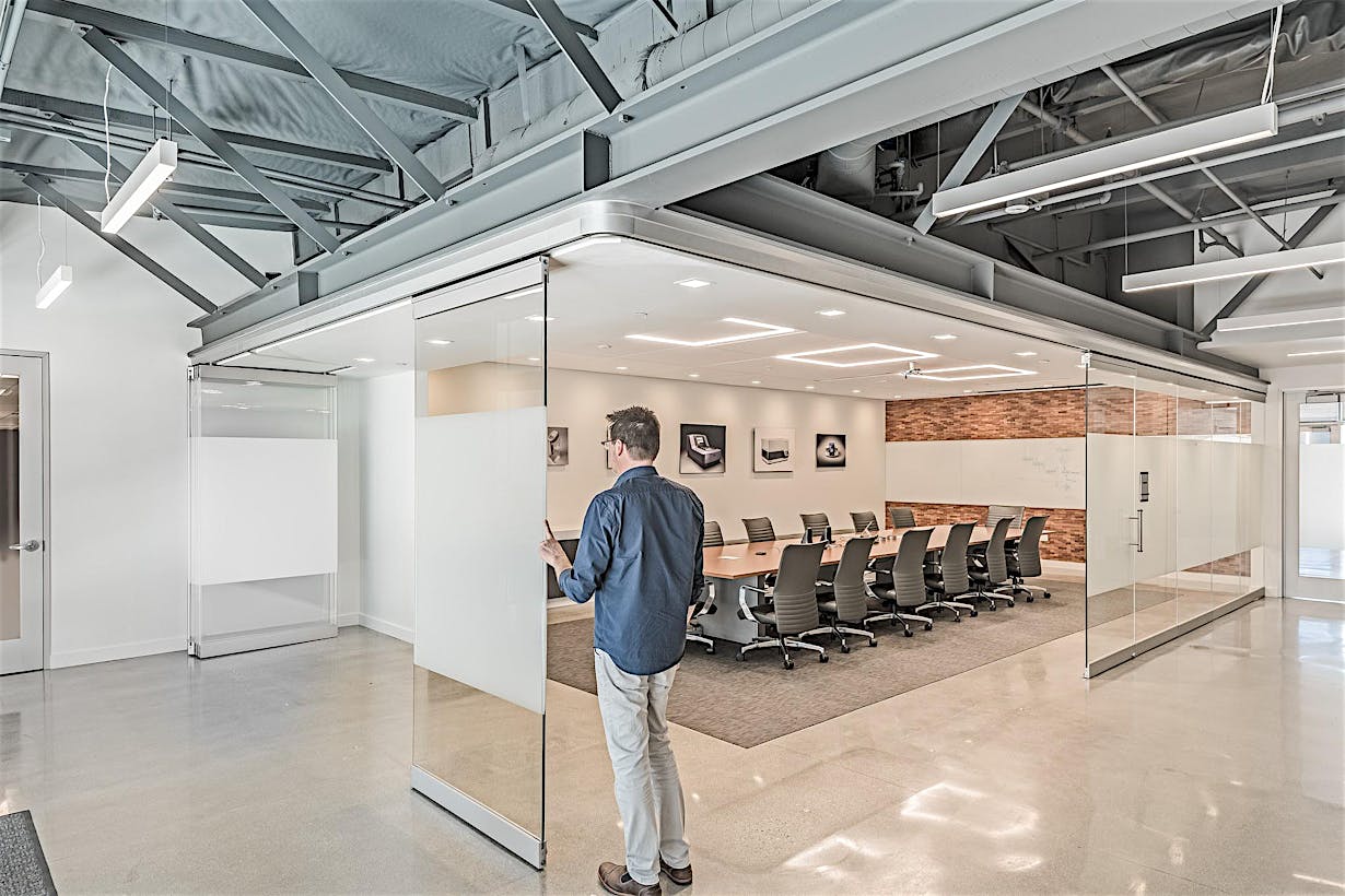 Office Boardroom walled on two sides by Sliding Glass Walls