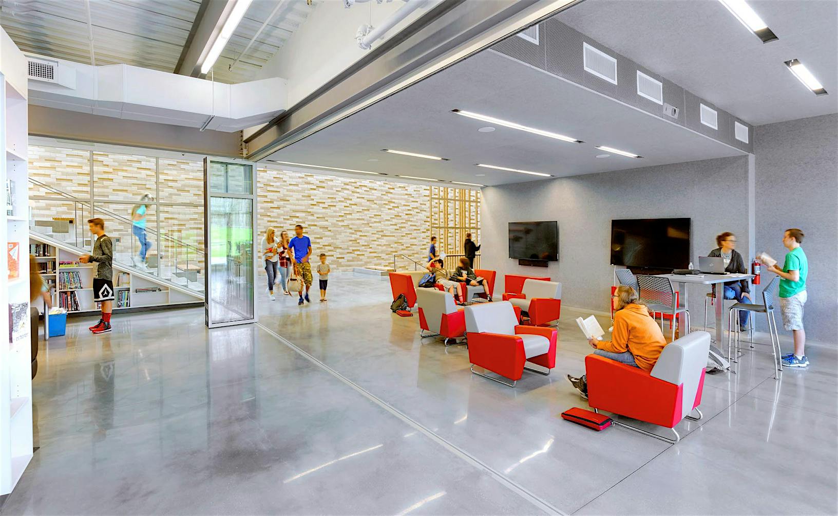 SL70 library lobby with red chairs partitioned by folding glass walls 