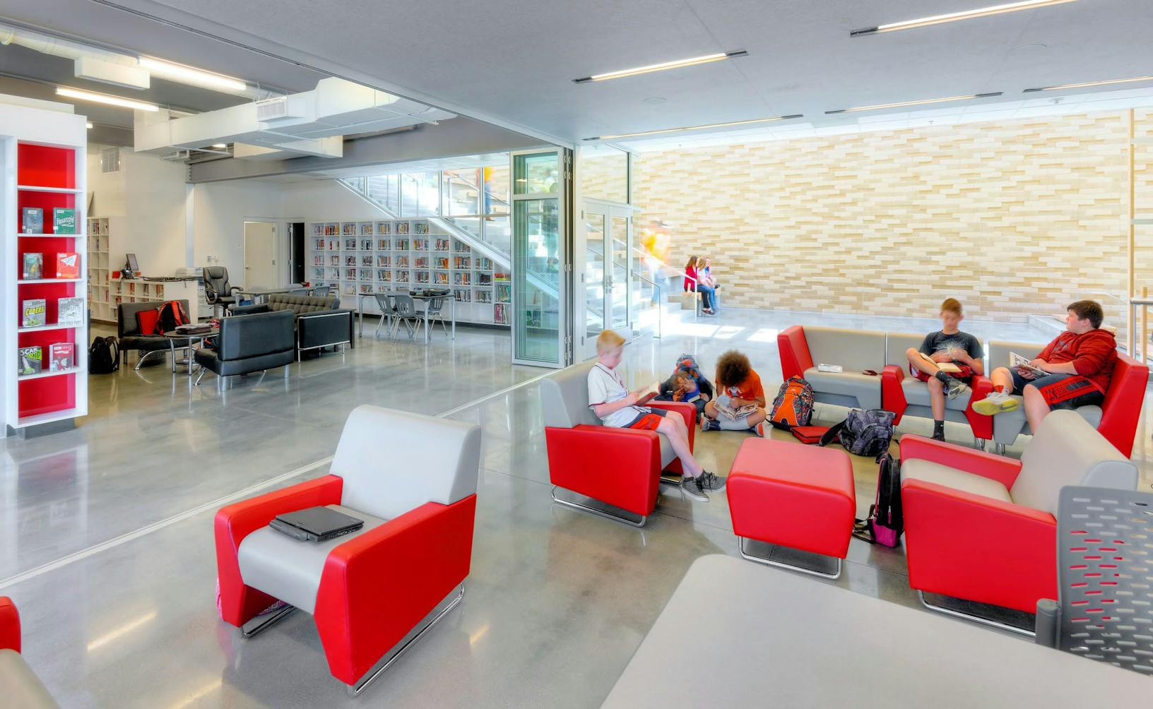 SL70 library lobby with red chairs partitioned by folding glass walls 