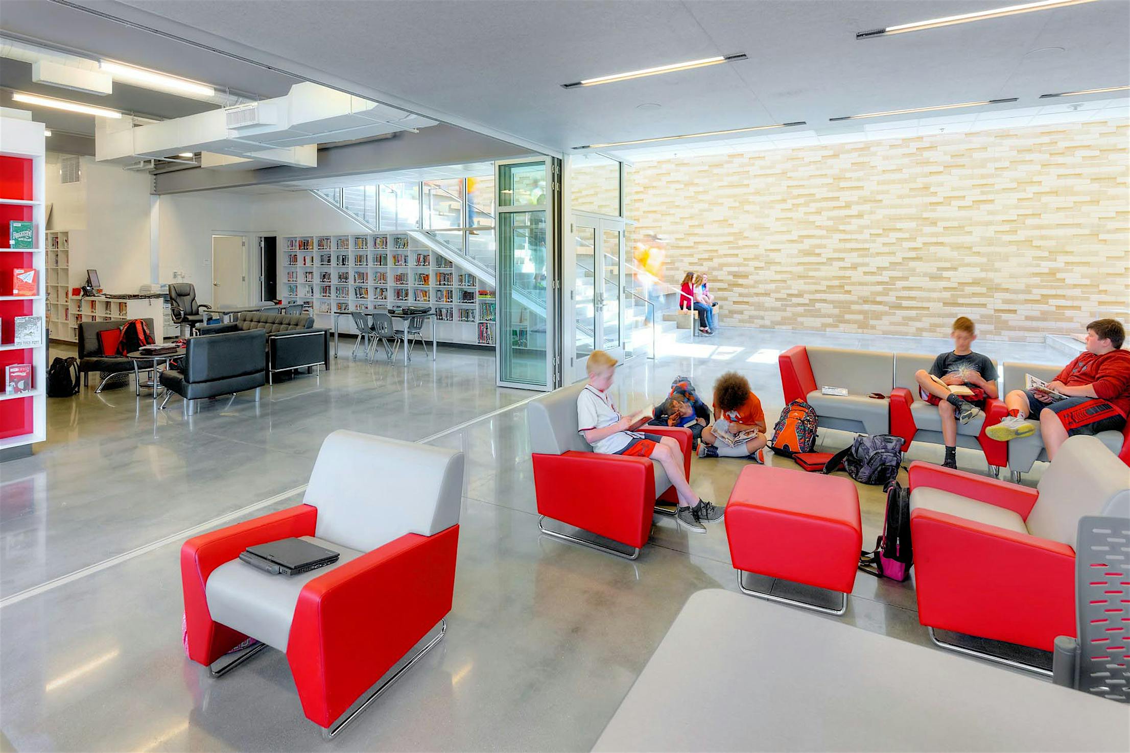 SL70 library lobby with red chairs partitioned by folding glass walls