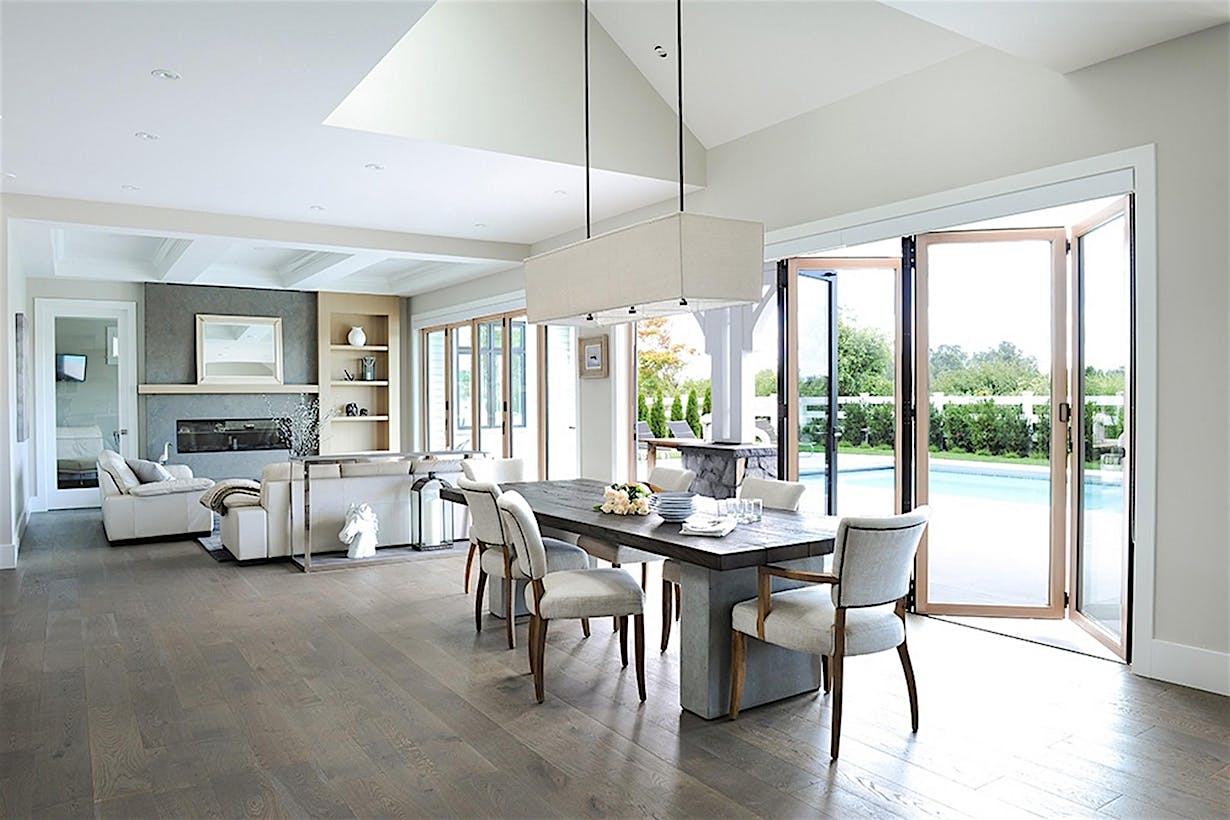 Retractable patio doors in Vancouver, BC integrate indoor and outdoor space, bringing seamless modern living environments