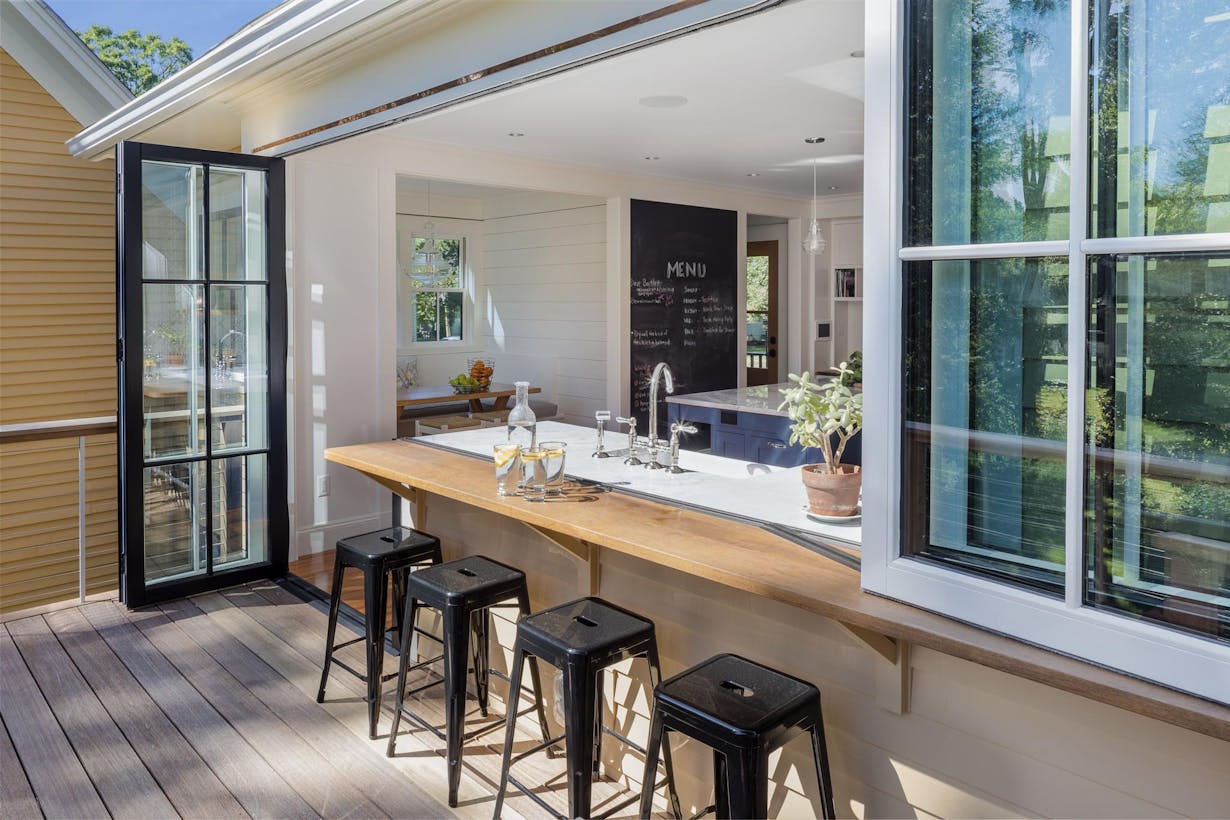 Kitchen window doors combination with bar stools and a view of the outdoors