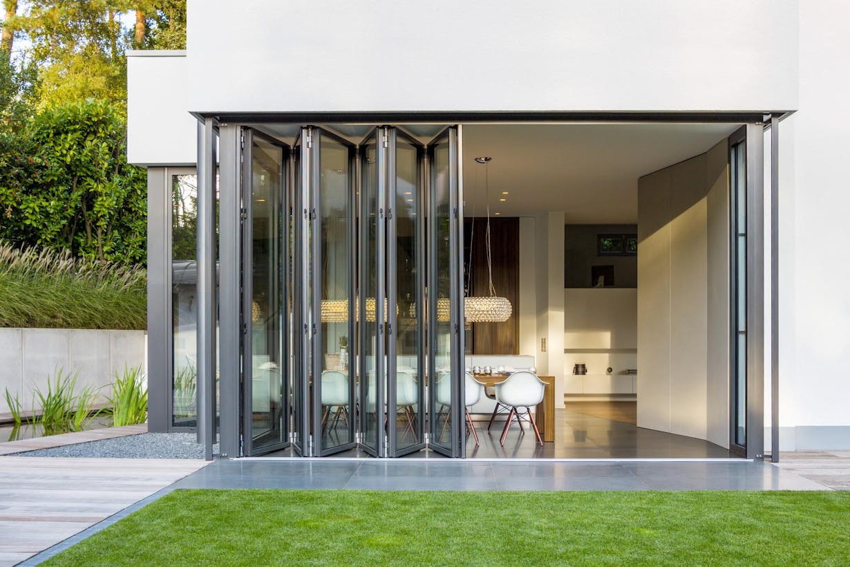 A modern home with folding glass doors