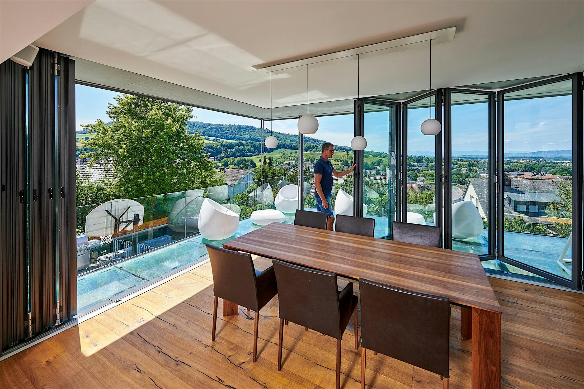 Dining room with open corner folding glass walls and view of the mountains