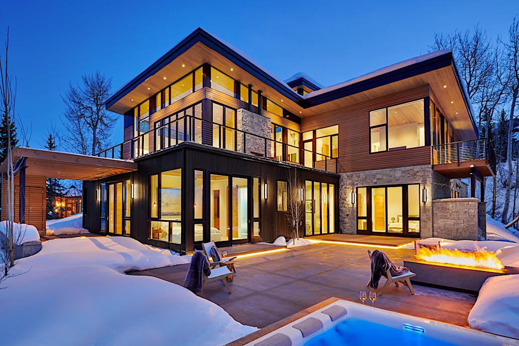 Retractable patio doors at Snowmass Village, CO residence improve energy efficiency and connect indoor-outdoor spaces
