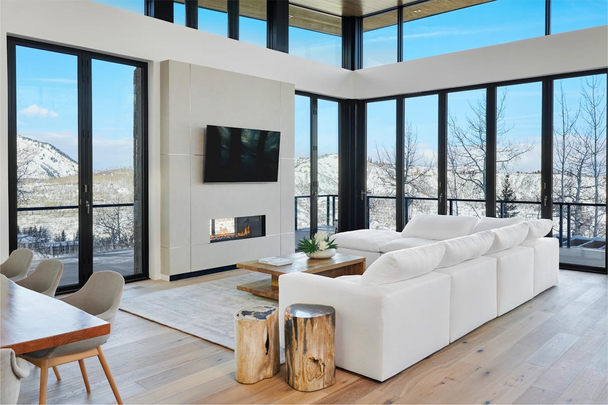 Modern living room with large patio doors performing in snow