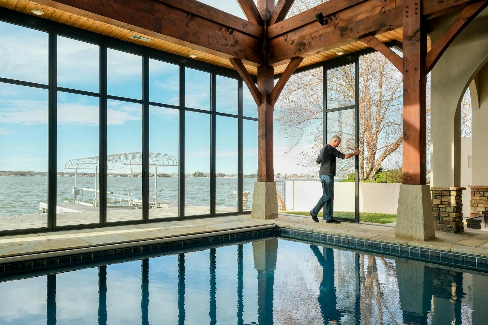HSW60 Lakeside pool pavilion - person sliding movable glass doors