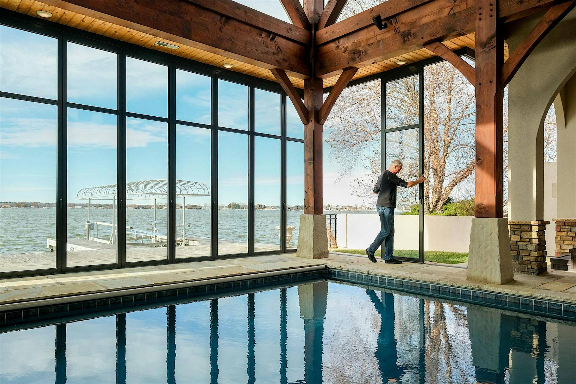 HSW60 Lakeside pool pavilion - person sliding movable glass doors