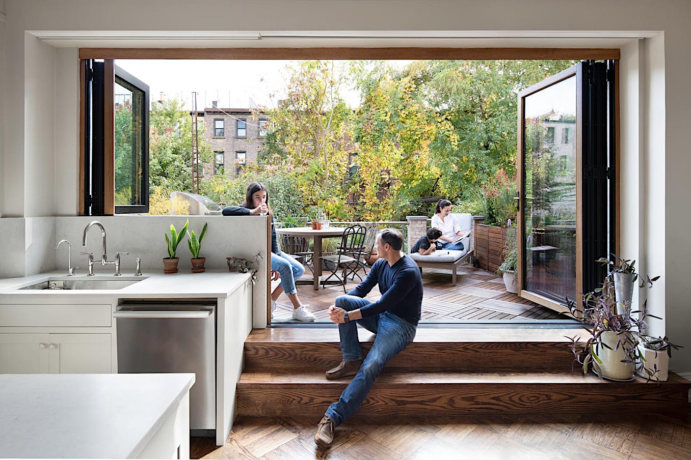 A spacious kitchen with large window door combination opens to an outdoor deck