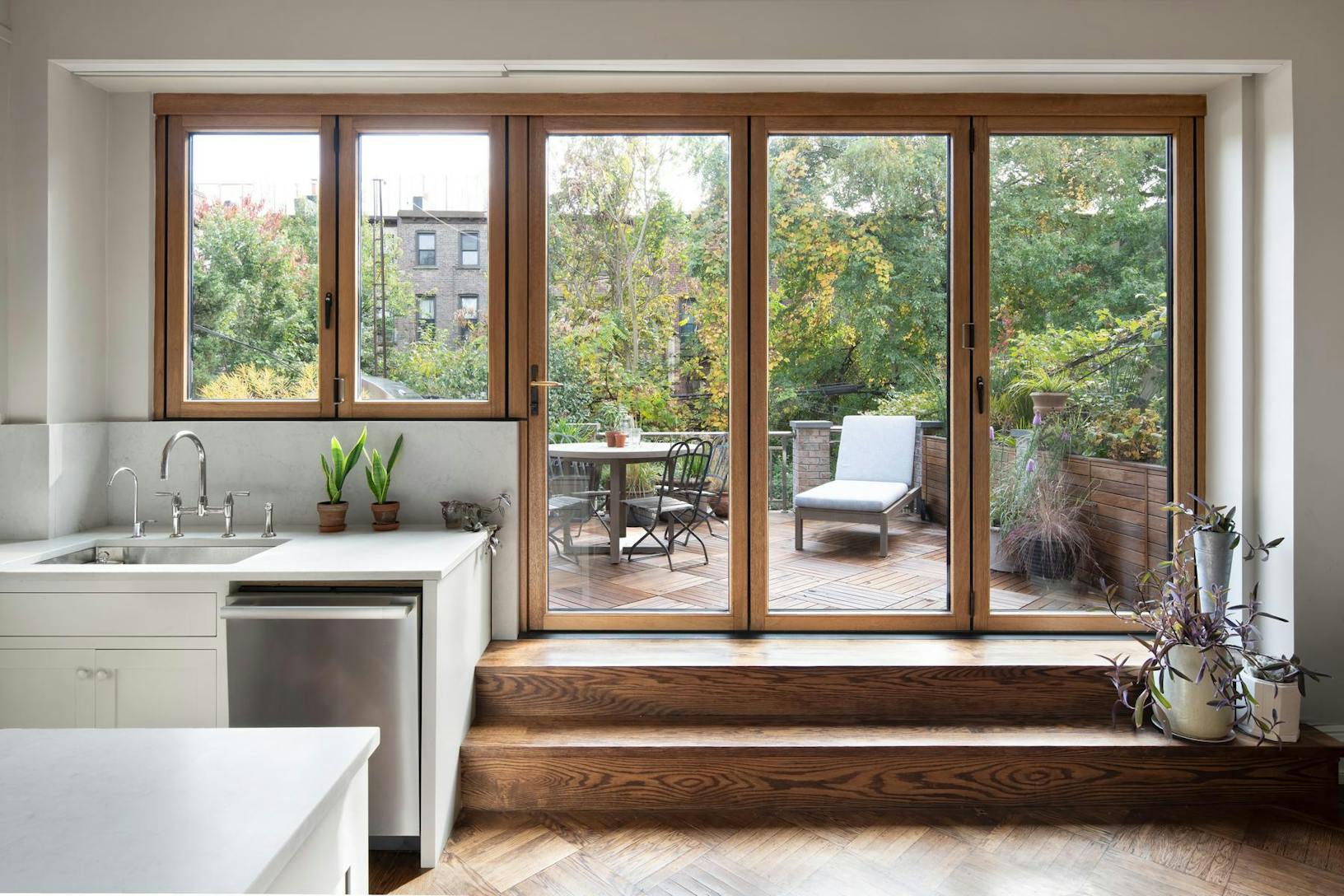 Dual-height wood framed bifolding glass windows and glass walls at Brooklyn Brownstone