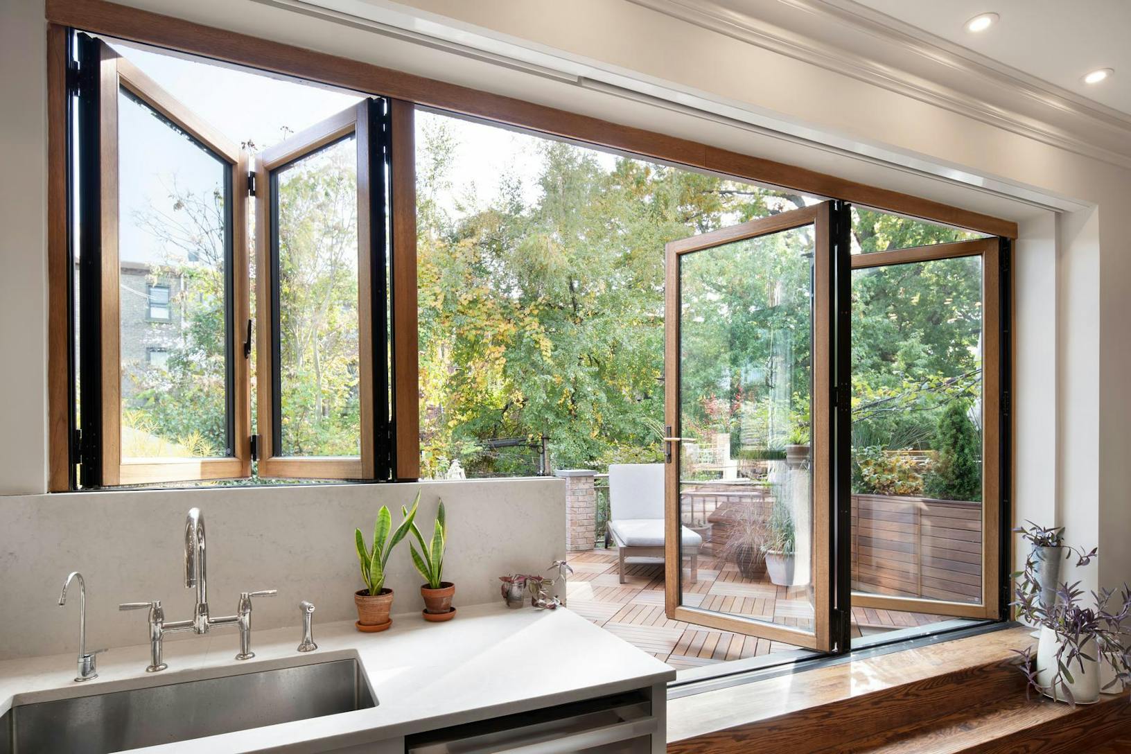 Dual-height wood framed bifolding glass windows and glass walls at Brooklyn Brownstone