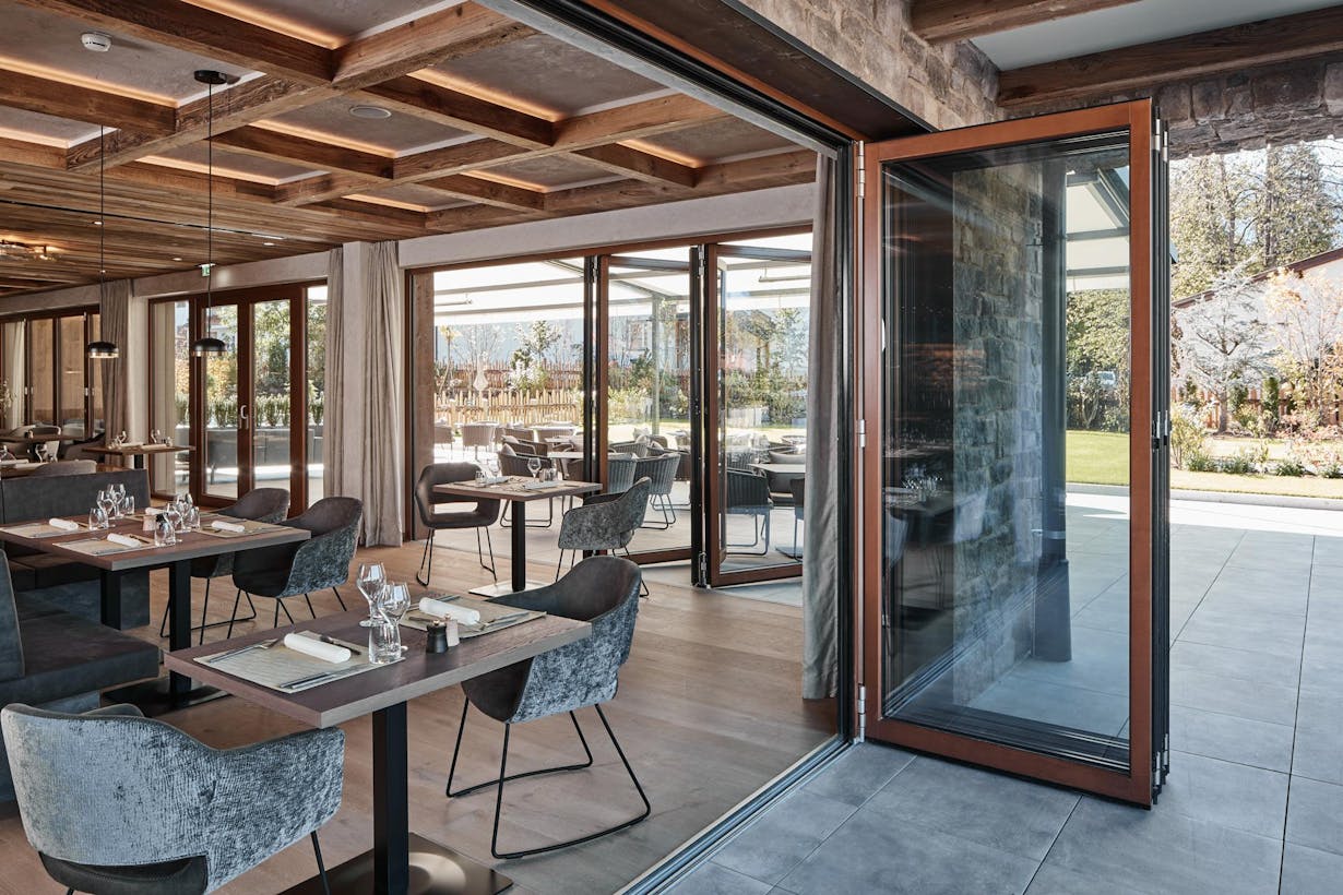 A restaurant with large wood framed glass doors