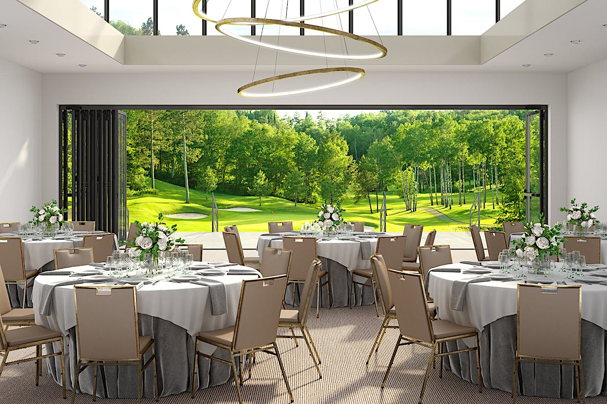 A banquet room with a view of a golf course, featuring commercial glass walls - doors stacked to the left