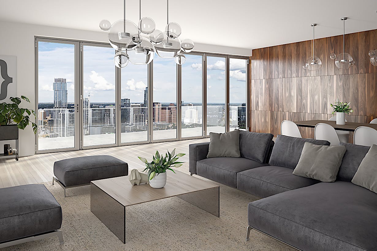 A high rise living room with folding glass walls providing a panoramic view of the city