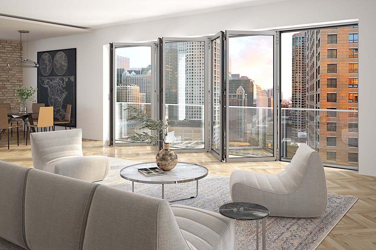 A living room with Folding Glass Walls framing a stunning view of the city