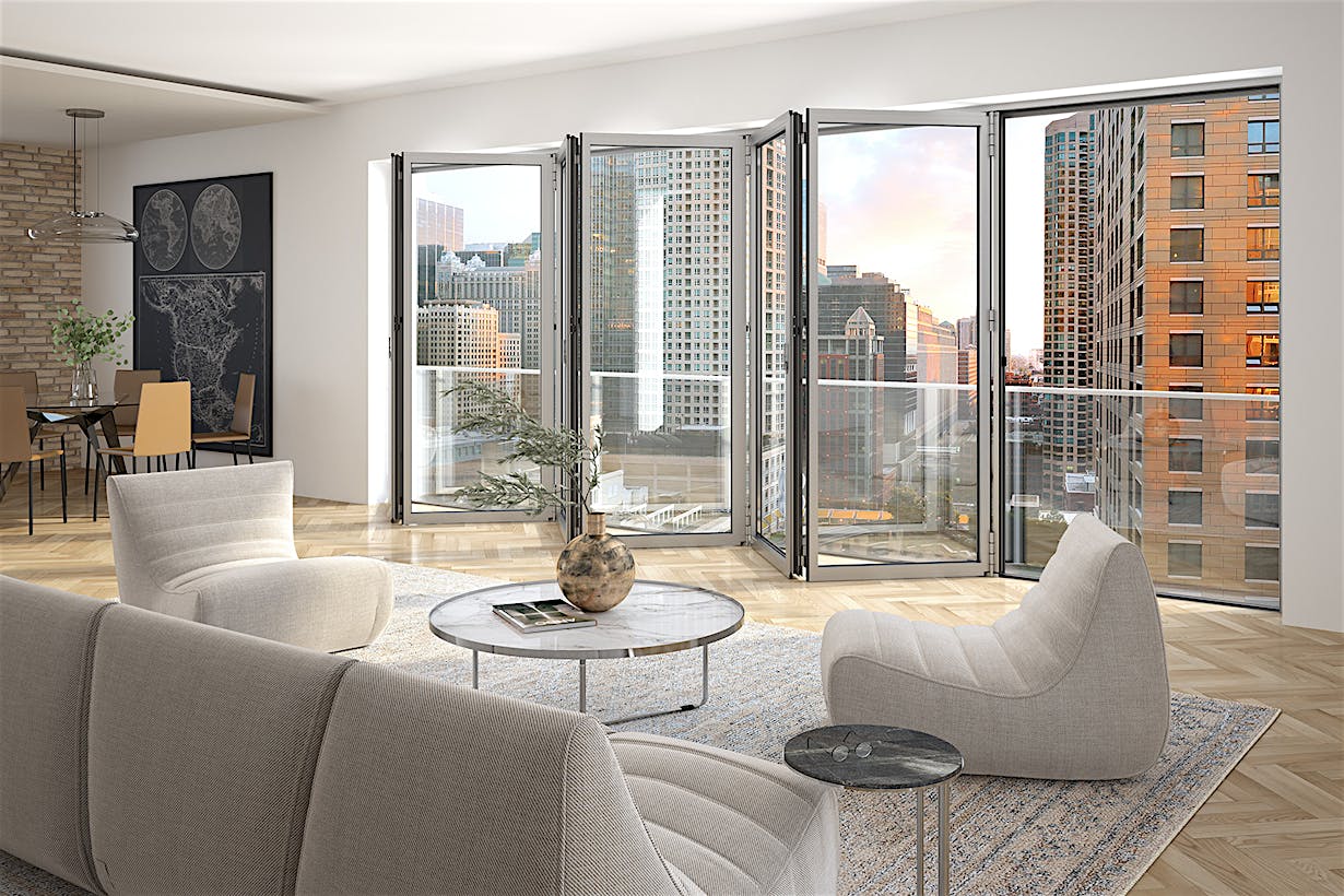 Modern living and dining area in a midrise apartment with a folding glass door opening to a city-view balcony.
