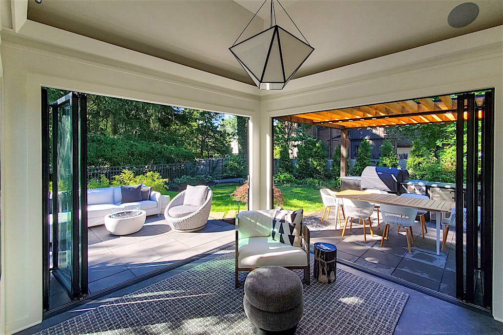 Bifold glass patio doors in Dorchester, MA integrate indoor and outdoor space, expanding living areas with modern elegance