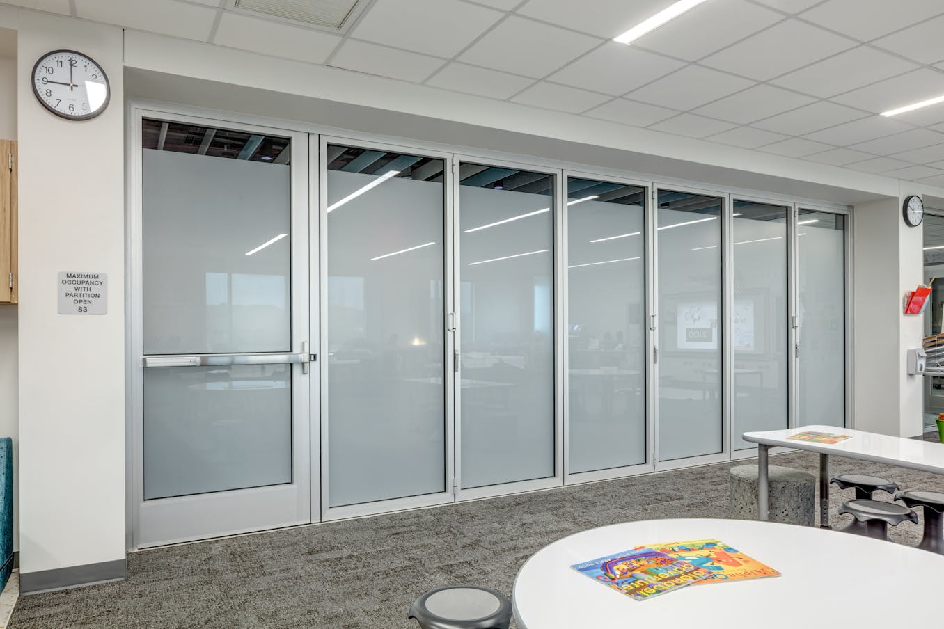 A classroom featuring frosted glass doors and a clock with the highest quality hardware